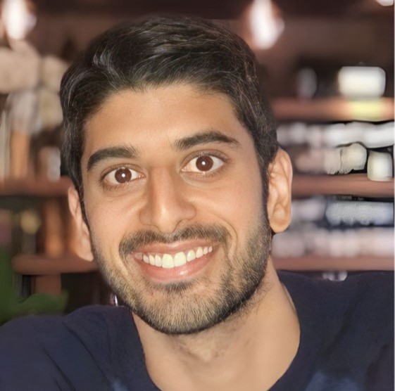 A square, close-up image of Dr Amit Seyan smiling at the camera.