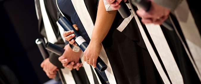 A close-up image of medical students holding certificates.
