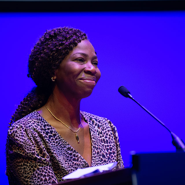 Bola Owolabi speaking at a podium