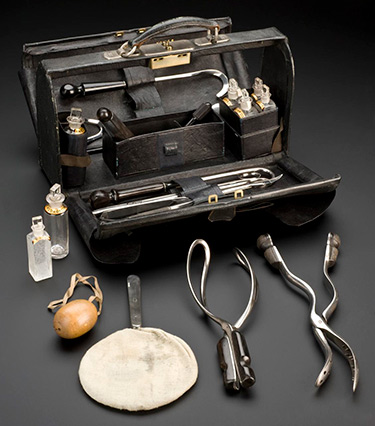 The midwifery bag contains various instruments and a matte black perspex material. Science Museum Group Collection© The Board of Trustees of the Science Museum.