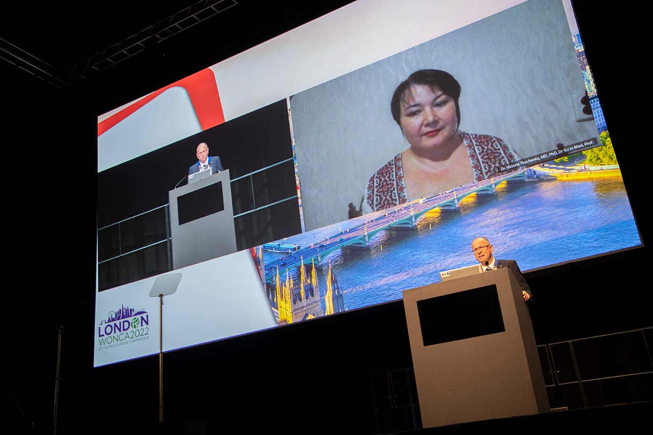 Victoria Tkachenko's image cast on a big screen on a stage