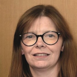 A headshot of Dr Ursula Mason with a plain background.