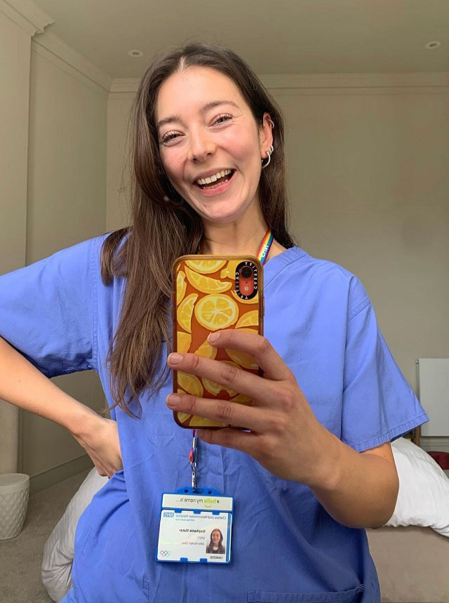 Dr Stephanie Slater holding up her phone to take a selfie. 