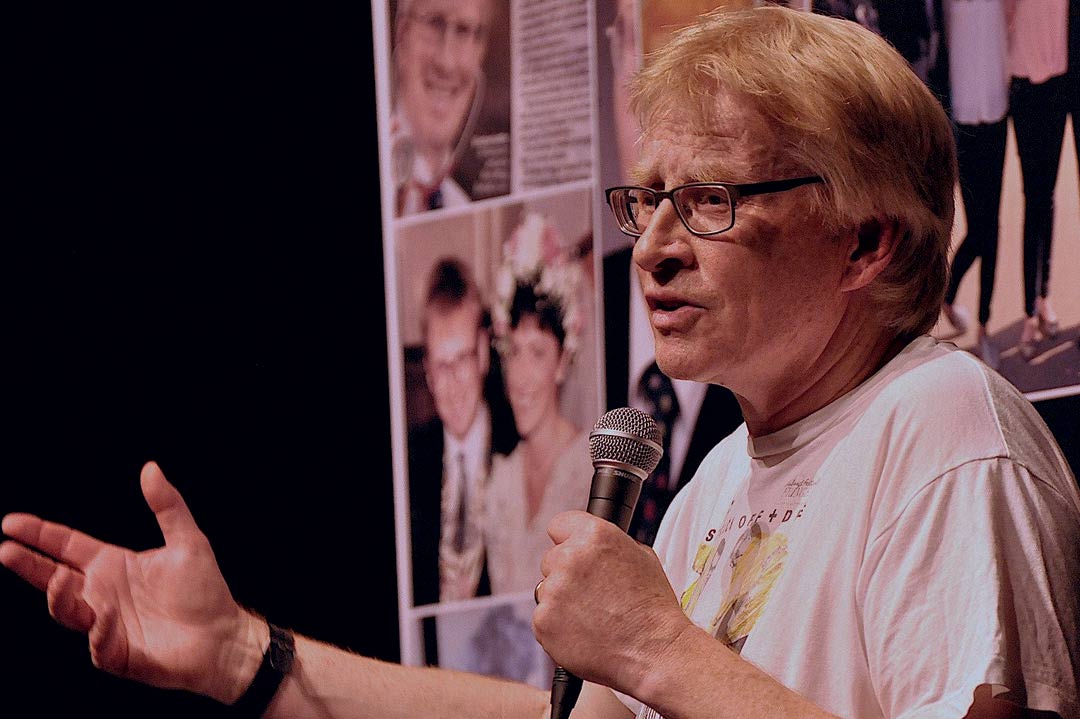 Phil Hammond speaking into a microphone