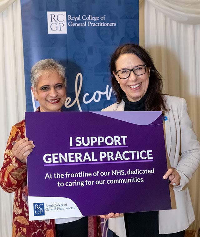 Professor Kamila Hawthorne holds a big purple sign with MP Debbie Abrahams.