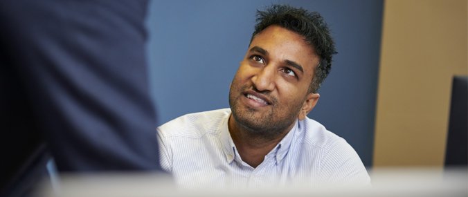 A male Doctor consulting a patient in his office 