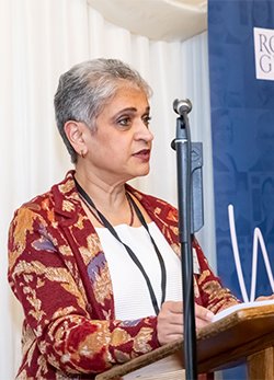 RCGP Chair Kamila Hawthorne stands at a podium to address an audience out of shot.