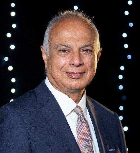 A headshot of Professor Kamlesh Khunti wearing a navy suit. 