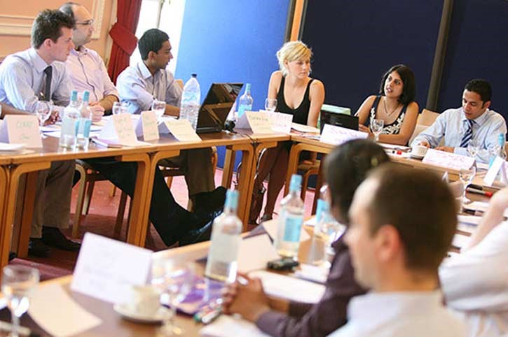 Group of people sitting around a u-shaped table